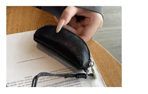 Black leather mini coin purse with lanyard, compact portable zipper pouch for daily use.