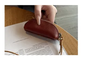 Mini genuine leather coin purse with strap, vintage vegetable-tanned semi-circular key storage bag.