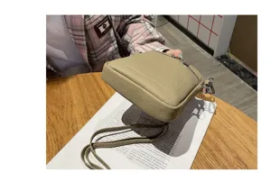 Detailed view of the mini leather phone crossbody bag, showing fine texture and hardware.