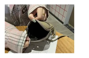 Genuine leather mini phone crossbody bag for women, stylish small shoulder bag detail.