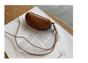 Mini genuine cowhide leather coin purse and lipstick bag with long neck strap for women.