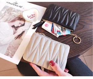 Compact women's leather mini wallet with zipper closure, stylish pleated coin purse design.