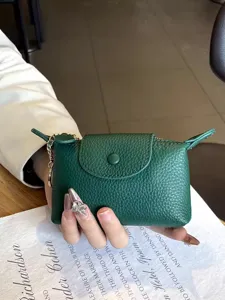 Green mini leather coin purse for women, compact small wallet with flap and keychain hook.