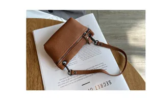 Genuine leather coin purse for women, mini soft cowhide zipper pouch with wrist strap chic detail.