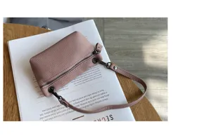 Detail shot of a women leather mini coin purse with zipper and short strap for daily use.