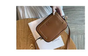 Genuine leather camera bag for women, retro brown crossbody shoulder bag with metal hardware.