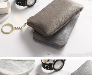 Close-up detail shot of genuine leather mini coin purses with metal key ring and dual zippers.