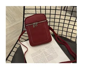Detail view of the red genuine leather mini crossbody phone bag, featuring soft cowhide and zip.