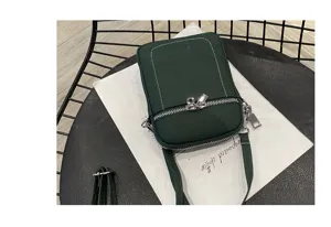 Close-up detail of the dark green leather phone bag showcasing fine stitching and metal zippers.