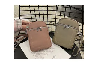 Detailed view of genuine leather mini cell phone crossbody bags in pink and khaki with dual zippers.