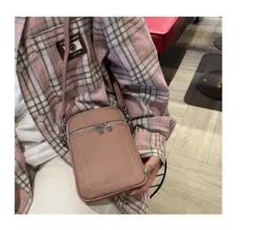 Small leather phone bag for women, stylish crossbody shoulder bag with zipper and metal hardware.