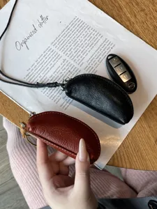 Genuine leather mini coin purse with lanyard, vintage cowhide key pouch for women storage.