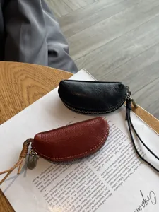 Mini genuine leather coin purse crescent dumpling shape lipstick storage bag with lanyard.