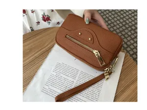 Detail view of genuine leather wristlet wallet featuring classic motorcycle design and hardware.