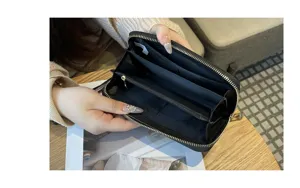 Detailed view of the black leather long zipper wallet showing spacious interior compartments.
