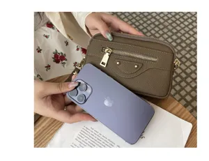 Genuine leather motorcycle clutch bag for women, large capacity double zipper handbag detail.