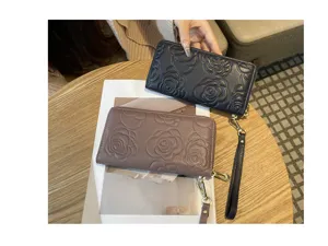 Women long leather wallet with elegant camellia embossed design, zipper closure and wrist strap.