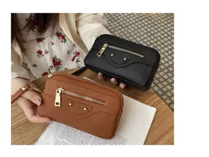 Genuine leather motorcycle clutch detail view, showing double zipper pockets and metal rivet design.
