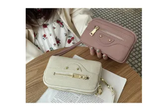 Leather motorcycle clutch bag with double zippers, stylish studs and handy wrist strap.