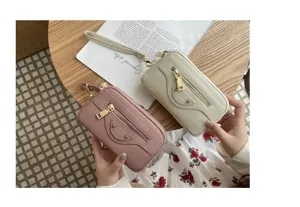 Genuine leather women clutch motorcycle bag detail shot, stylish double zipper design with wrist strap.