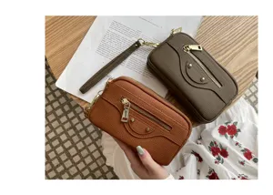 Genuine leather motorcycle clutch bag detail showing double zippers and handy wrist strap.