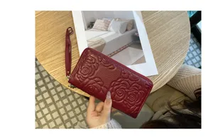 Genuine leather long wallet for women with elegant embossed camellia flower pattern, single zipper.
