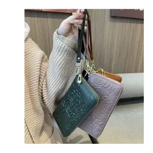 Genuine leather long wallet for women with camellia floral embossed pattern and wrist strap