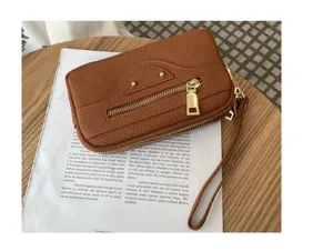 Brown genuine leather women's clutch bag with motorcycle design, dual zippers and large capacity.
