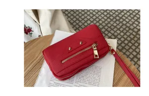 Red genuine leather women handbag featuring stylish metal studs and practical double zipper design.
