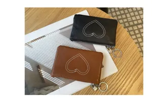 Mini leather coin purse with heart stitching, compact zipper card wallet for women.