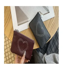 Detailed view of genuine leather mini coin purse with cute heart stitching and secure zipper closure.