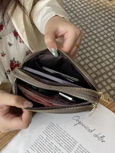 Genuine leather double zipper women's clutch handbag showing large capacity interior space.