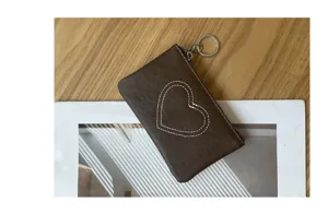 Brown leather coin purse with heart stitching and keyring, compact card holder for women.