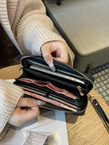 Black genuine leather long zip wallet for women with card slots, cash compartments, and phone.