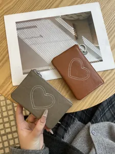 Compact leather coin purse and card holder with cute heart stitching design for daily use.