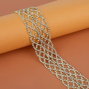 Gold rhinestone mesh chain detail, sparkling crystal grid strap for stylish body jewelry design.