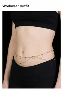 Detailed shot of a delicate gold double layer waist chain with rhinestones and heart pendant.