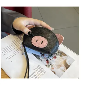 Cute black leather coin purse with adorable pink pig ears and snout design, portable wrist strap.