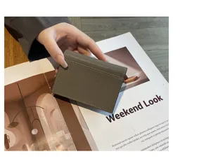 Grey leather card holder detail, minimalist envelope design, premium cowhide accessory.