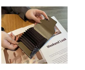 Detailed view of the accordion leather card holder showing multi card slots and open interior.