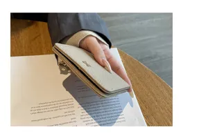 Minimalist leather cardholder wallet, compact short purse with textured finish detail.
