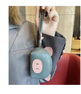 Close-up detail shot of the cute mini pig genuine leather coin purse with wrist strap.