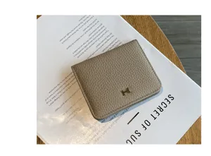 Minimalist genuine leather short wallet for women, compact card holder with stylish metal clasp.