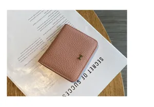 Minimalist pink genuine leather short wallet with gold tone hardware for women daily use.