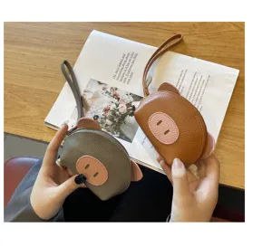 Cute leather mini coin purse with wrist strap, adorable pig design for women and girls daily use.