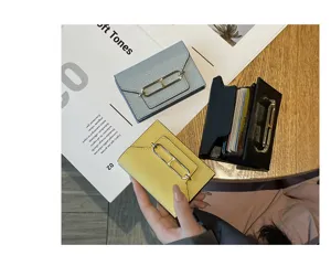 Leather card holder wallet for women, multi-slot slim card case with metal lock detail.