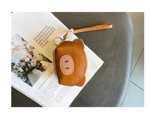Cute mini genuine leather coin purse with cute pig design and wrist strap for women.