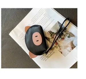 Cute mini leather coin purse for women, black and pink animal design with wrist strap.