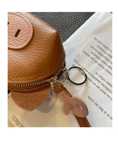 Cute brown leather coin purse with pink accents, compact mini wallet with zipper and keyring.