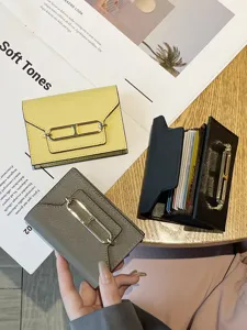 Women's genuine leather card holder with multi slots, elegant metal clasp and large capacity.